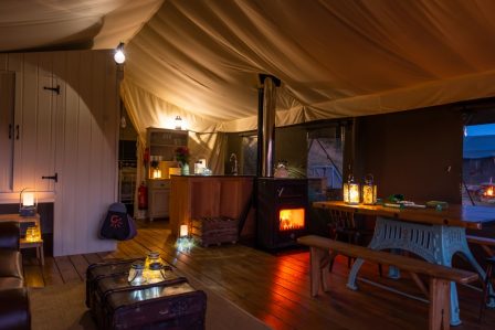 The inside of Afon safari tent at night